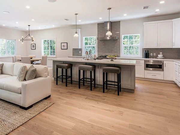 Open kitchen uses solid hardwood flooring.