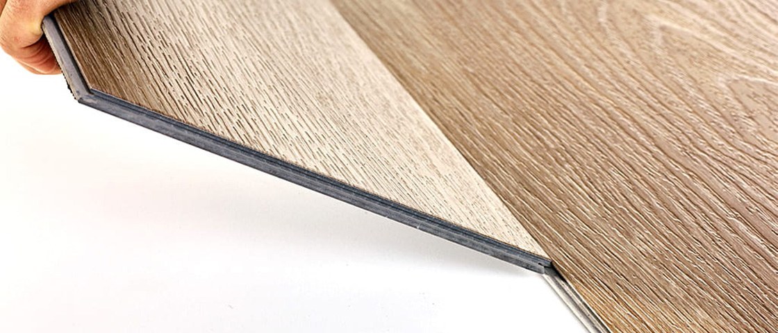 There are two pieces of LVT flooring being installed on the ground.