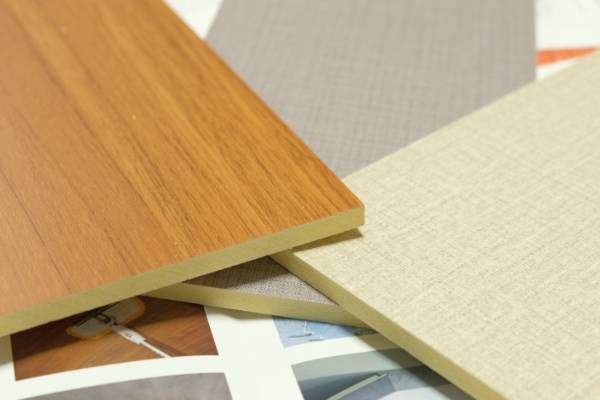 Three WPC solid wall panel samples in different colors