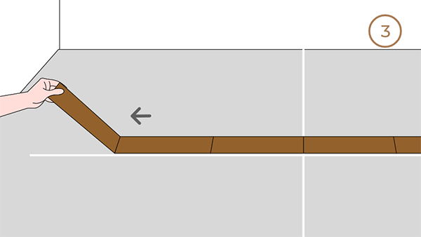 Workers laying the flooring along the horizontal lines.