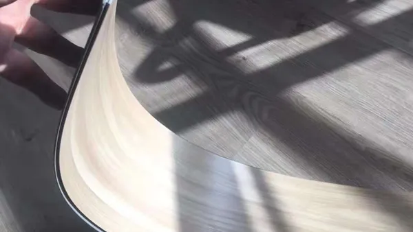 Workers testing SPC flooring flexibility and rigidity