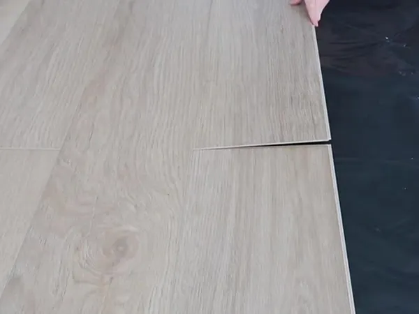 Workers are installing SPC flooring.