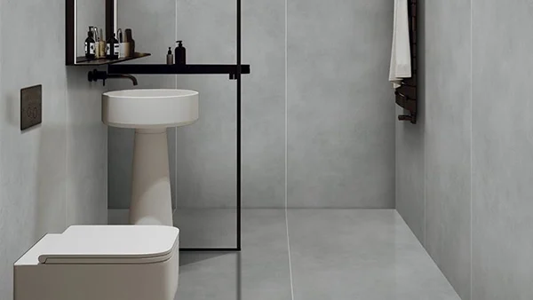 El baño cuenta con paneles de pared SPC con una superficie lisa y un tono gris minimalista.