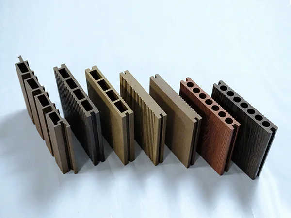 The desk displays solid and hollow WPC panels in various colors and structures.